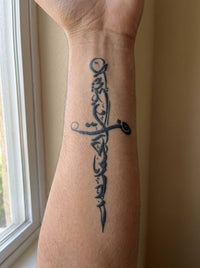 Dagger temporary tattoo shown on a forearm