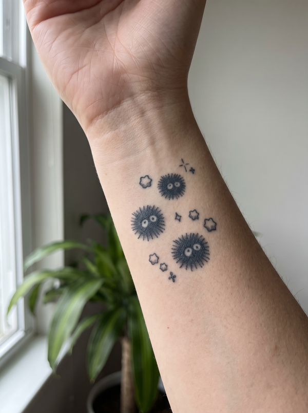 Soot Sprite temporary tattoo shown on a wrist