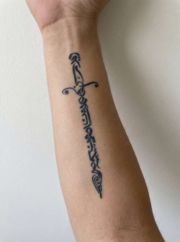 Sword temporary tattoo shown on a forearm