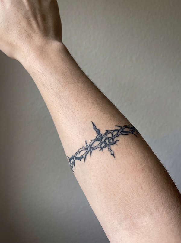 Wrapping Thorns temporary tattoo shown wrapping a forearm
