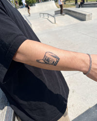 Jotaro's Cap semi-permanent tattoo on forearm
