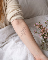 Sparkles semi-permanent tattoo on inner forearm